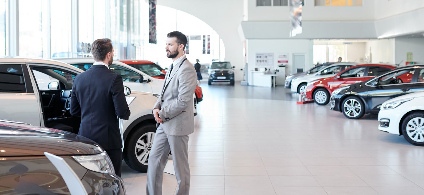 Men at auto dealership